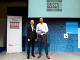 Jörg Harjes (on the right), Head of Marketing Independent Aftermarket at HELLA, receives the Best Brand award from Klaus Reger, General Sales Manager at Huss-Verlag.